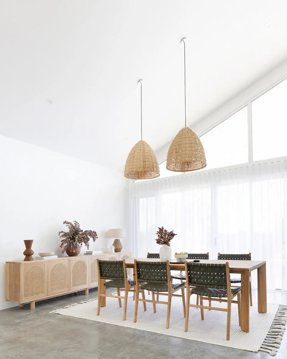 A contemporary Luca Woven Leather Dining Chair with a solid teak frame and olive dyed leather, showing a complete dining set