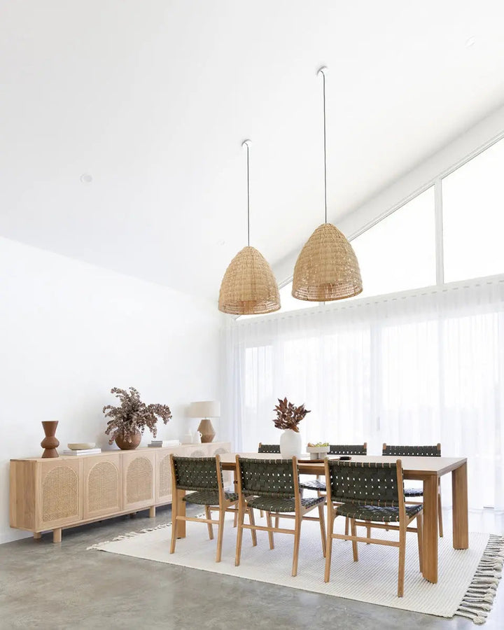 A contemporary Luca Woven Leather Dining Chair with a solid teak frame and olive dyed leather, showing a complete dining set