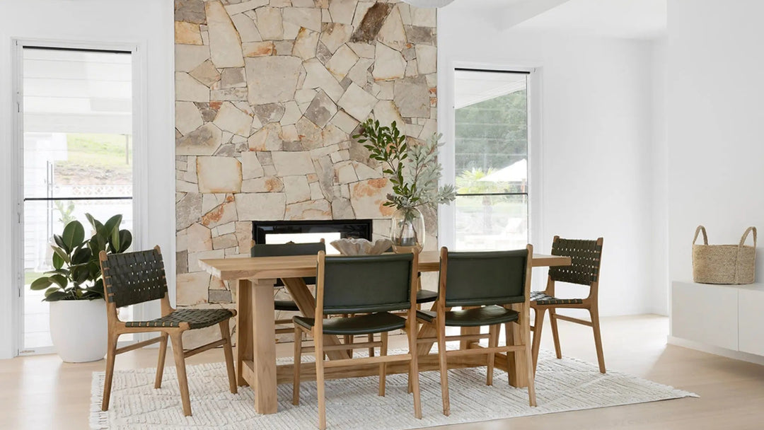 A contemporary Luca Woven Leather Dining Chair with a solid teak frame and olive dyed leather, showing a dining room set with the Bruges Dining Table
