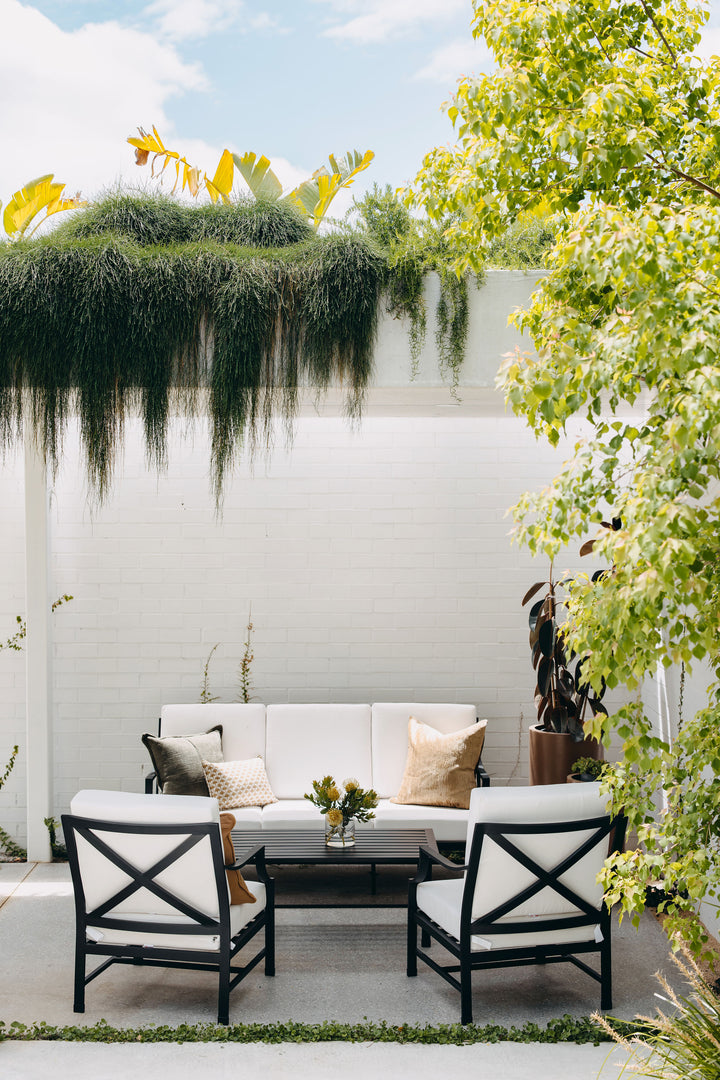 Portofino Outdoor Lounge Set styled in an outdoor space with cascading greenery
