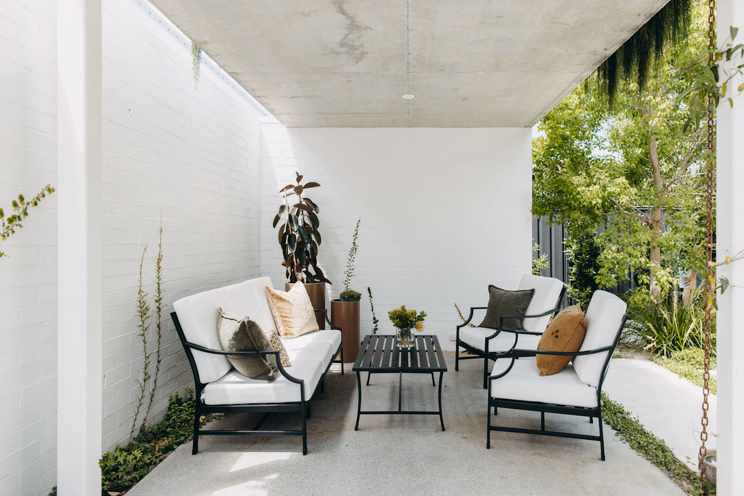 Side view of Portofino Lounge Set in Black styled in a covered area.  