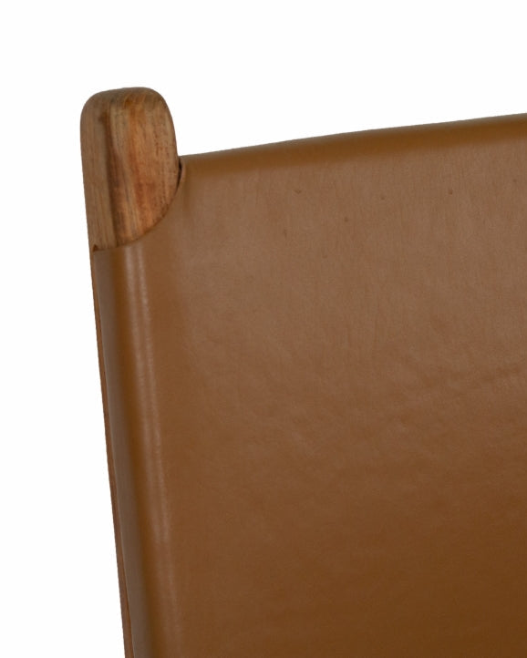 A contemporary Sutton Leather Dining Chair with a teak wooden frame, and brown leather upholstery.